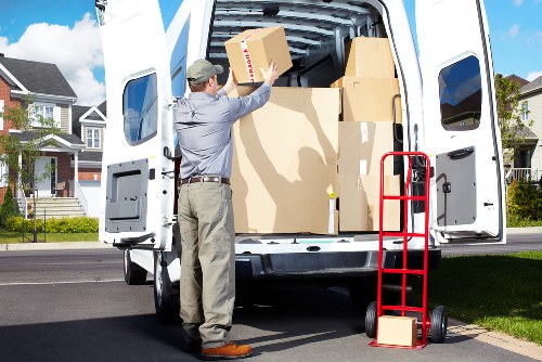 Team coordinating office furniture transport in Docklands near high-rise buildings