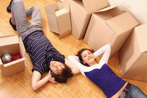 Moving van loading household items from a modern Docklands property