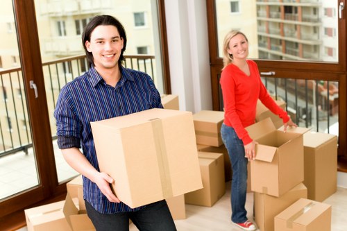 Trained moving team using PPE while handling furniture safely